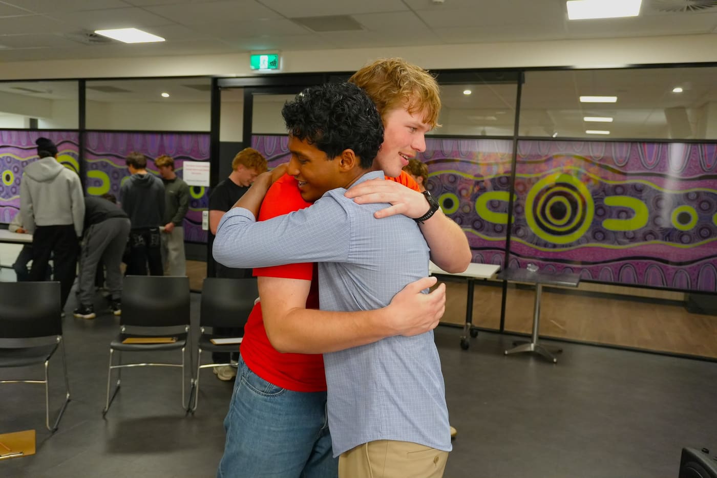 Two participants hugging at the end of a session