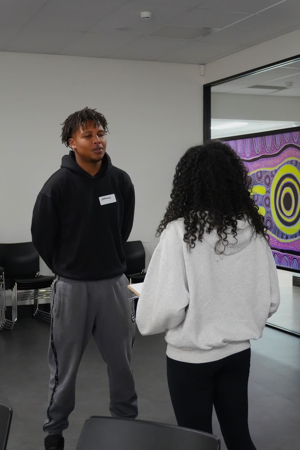 Two participants standing and talking one to one